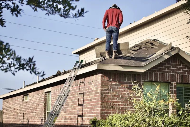 Professional roofer working on a residential roof in Berdines Corners